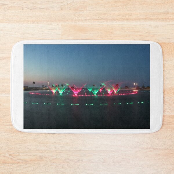 Item preview, Colorful Illuminated Fountain Show At Dusk With Water Jets Over Waterfront designed and sold by Nmallia.