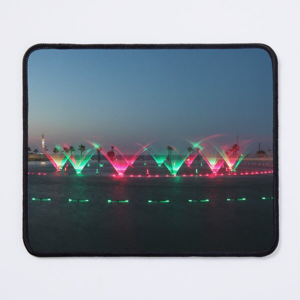 Item preview, Colorful Illuminated Fountain Show At Dusk With Water Jets Over Waterfront designed and sold by Nmallia.