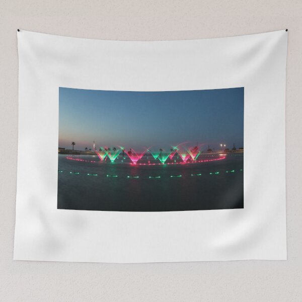 Item preview, Colorful Illuminated Fountain Show At Dusk With Water Jets Over Waterfront designed and sold by Nmallia.