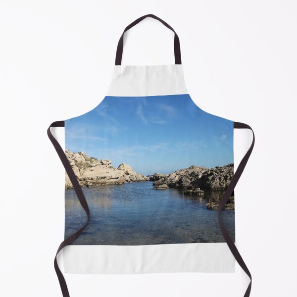 Item preview, Sunlit Rocky Coastline With Clear Blue Water and Calm Sea Under A Bright Sky designed and sold by Nmallia.