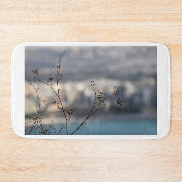 Item preview, Silhouetted Wildflower Stems in Foreground With Blurred Coastal Cityscape and Sea Background designed and sold by Nmallia.