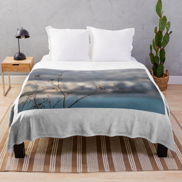 Item preview, Silhouetted Wildflower Stems in Foreground With Blurred Coastal Cityscape and Sea Background designed and sold by Nmallia.