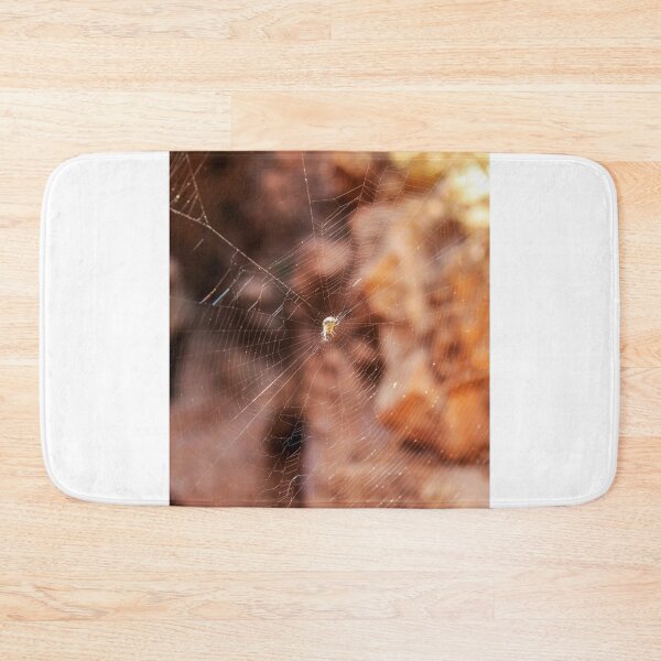 Item preview, Close-Up Spider Web With Small Spider at Center and Warm Golden Bokeh Background designed and sold by Nmallia.