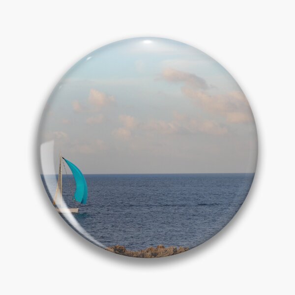 Item preview, Sailboat With Bright Blue Sail Cruising Near Rocky Shoreline Under Calm Sky And Open Horizon designed and sold by Nmallia.