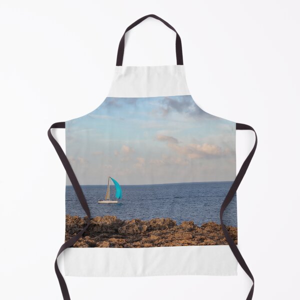 Item preview, Sailboat With Bright Blue Sail Cruising Near Rocky Shoreline Under Calm Sky And Open Horizon designed and sold by Nmallia.