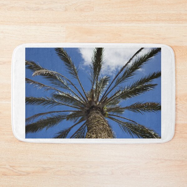 Item preview, Looking Up at a Tall Palm Tree Against a Bright Blue Sky With Wispy Clouds designed and sold by Nmallia.