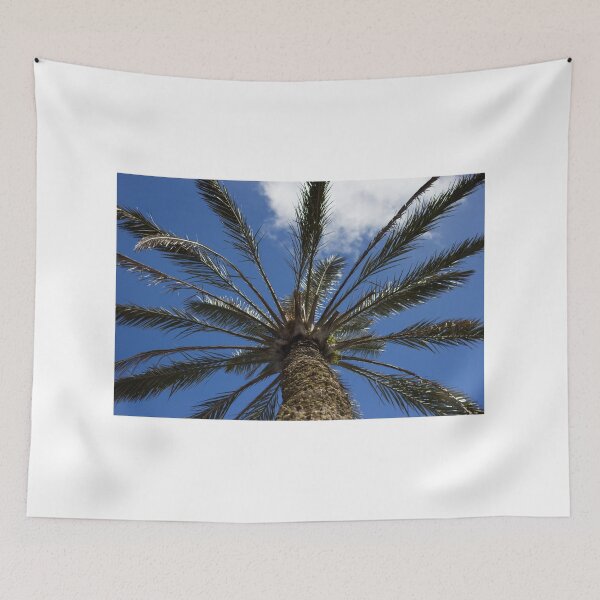 Item preview, Looking Up at a Tall Palm Tree Against a Bright Blue Sky With Wispy Clouds designed and sold by Nmallia.