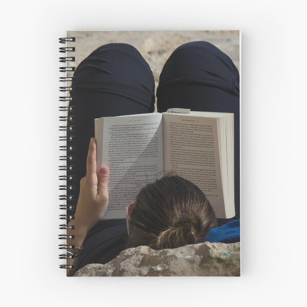 Item preview, Woman Reading a Book While Relaxing on a Rocky Beach Towel in Sunlight and Leisure designed and sold by Nmallia.