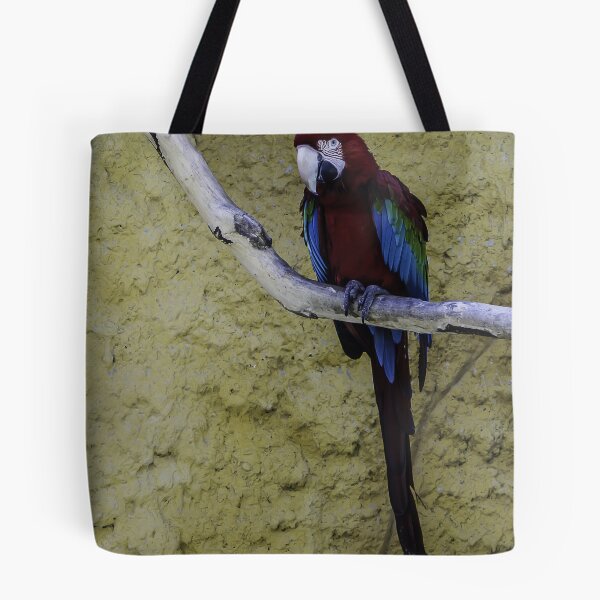 Item preview, Colorful Scarlet Macaw Perched on Branch Against Textured Yellow Background, Tropical Bird Portrait designed and sold by Nmallia.