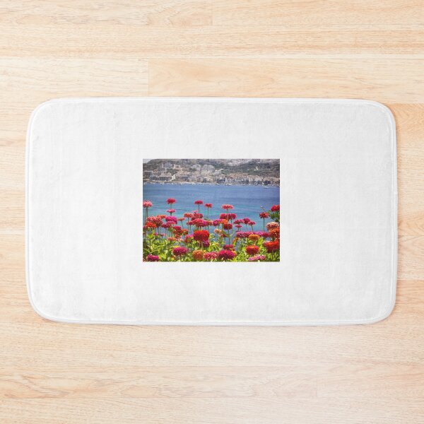 Item preview, Colorful Zinnias in Bloom Overlooking Turquoise Sea and Charming Coastal Town on a Sunny Day designed and sold by Nmallia.