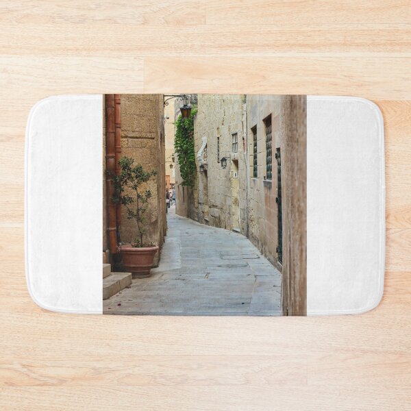 Item preview, Sunlit Narrow Stone Alley With Lanterns and Restaurant Sign in Historic Old Town designed and sold by Nmallia.
