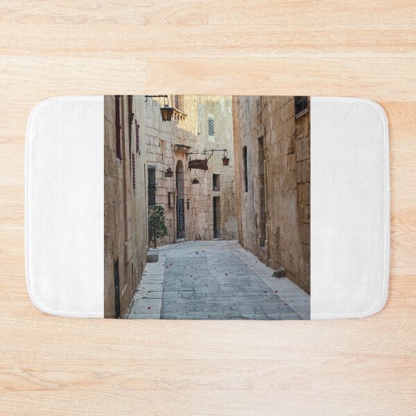 Item preview, Sunlit Narrow Stone Alley With Lanterns and Restaurant Sign in Historic Old Town designed and sold by Nmallia.