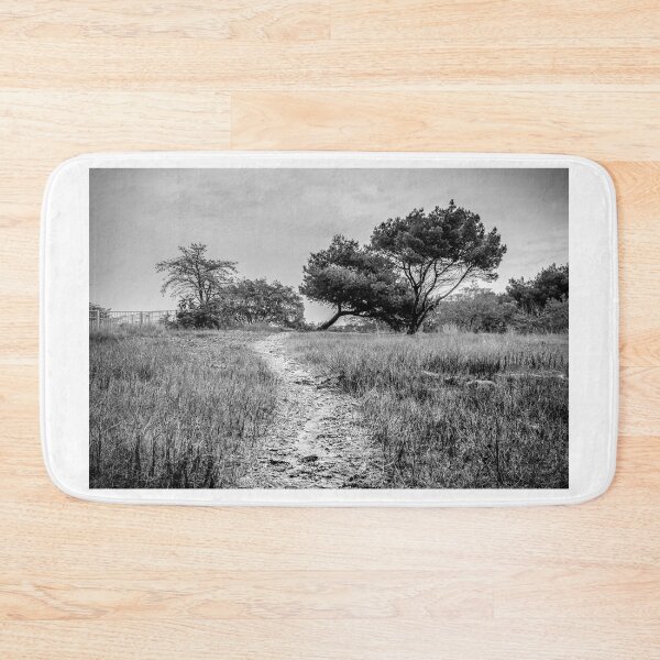Item preview, Lonely Dirt Path Through Tall Grass Leading To Windblown Trees In Black And White Landscape designed and sold by Nmallia.