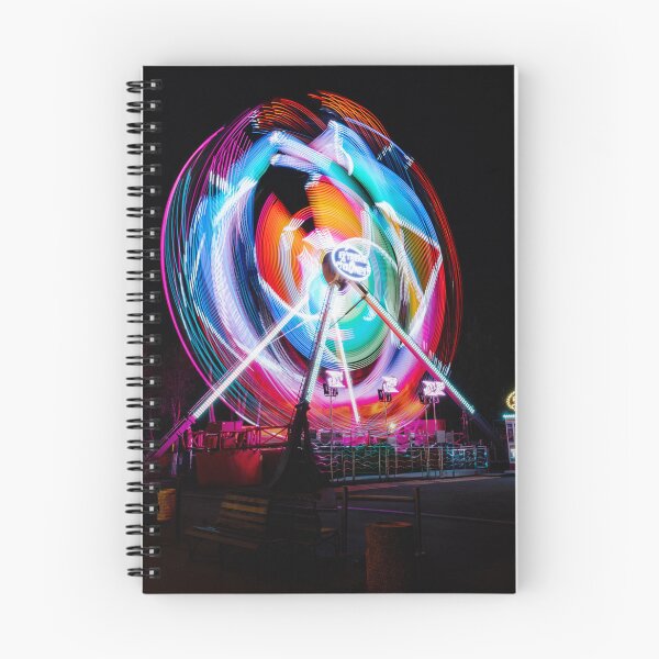 Item preview, Abstract rainbow light trails of a spinning carnival ride at night designed and sold by AndreiWBU.