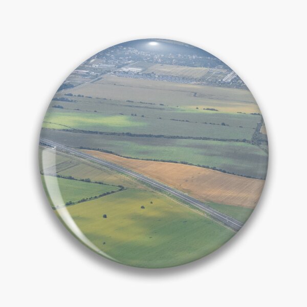 Item preview, Aerial view from an airplane window over green patchwork farmland designed and sold by AndreiWBU.