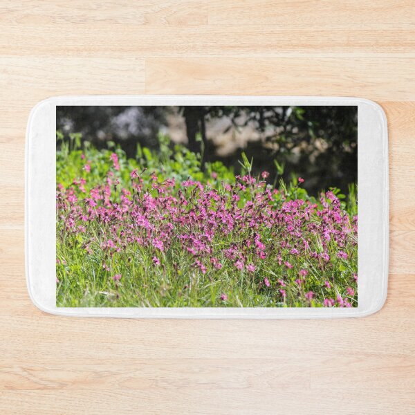 Item preview, Pink Wildflowers in a Sunny Spring Meadow With Green Grass and Soft Background Trees designed and sold by Nmallia.