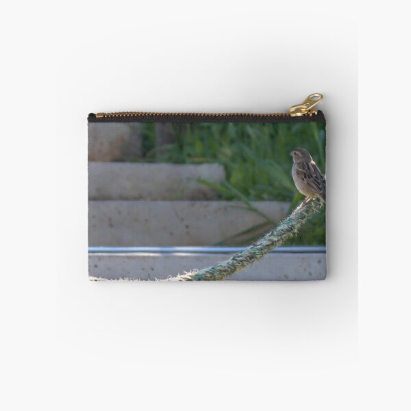 Item preview, Small Sparrow Perched on Frayed Rope Over Concrete Steps With Greenery in Soft Morning Light designed and sold by Nmallia.