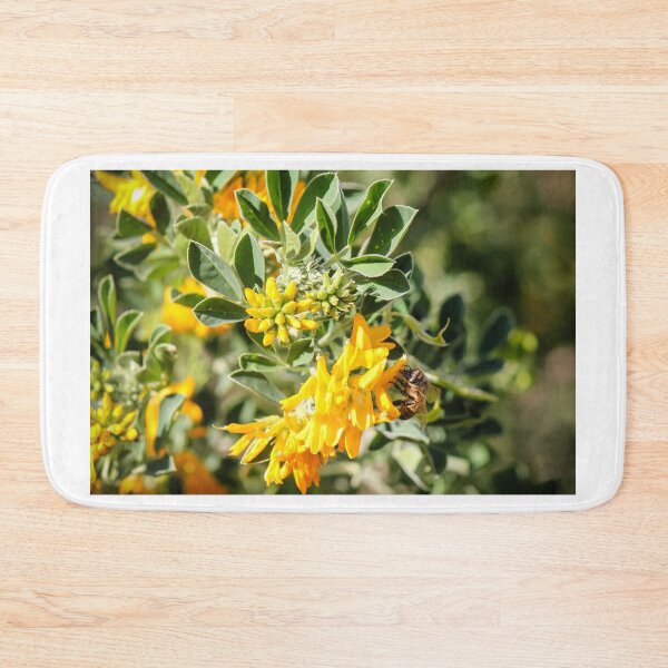 Item preview, Bee Pollinating Bright Yellow Wildflowers Among Green Leaves In Sunny Natural Garden Setting designed and sold by Nmallia.