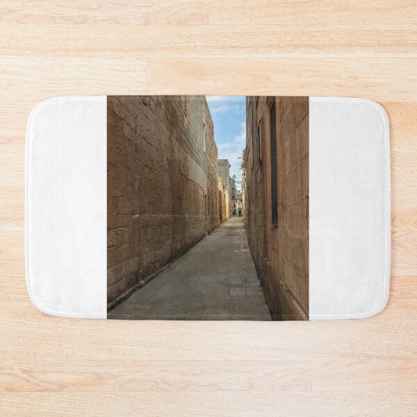 Item preview, Narrow Stone Alley Through Historic Old Town With Sunlit Passage And Distant Figure designed and sold by Nmallia.
