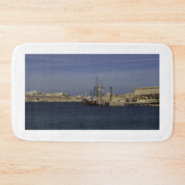 Item preview, Red Cargo Ship Docked Beside Historic Coastal Fort At Calm Harbor Under Blue Sky designed and sold by Nmallia.