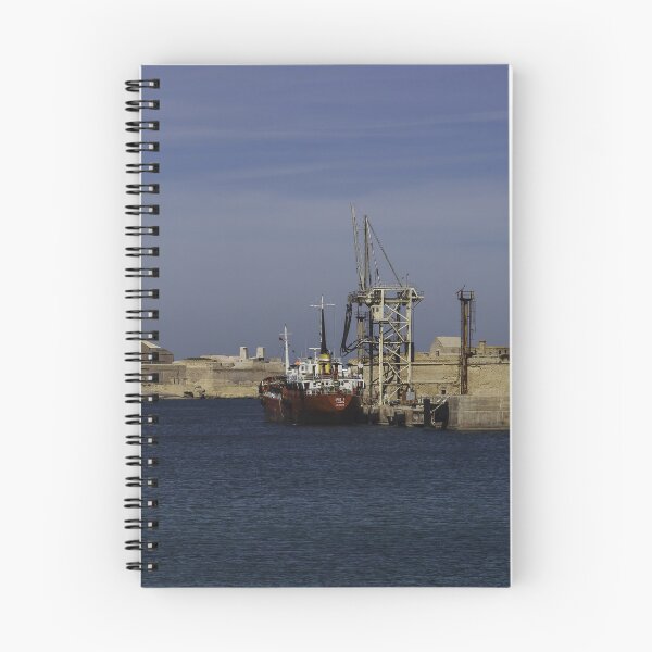Item preview, Red Cargo Ship Docked Beside Historic Coastal Fort At Calm Harbor Under Blue Sky designed and sold by Nmallia.