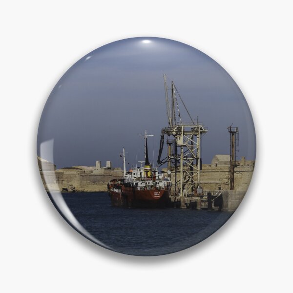 Item preview, Red Cargo Ship Docked Beside Historic Coastal Fort At Calm Harbor Under Blue Sky designed and sold by Nmallia.