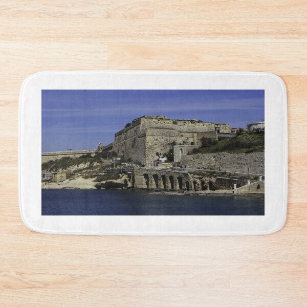 Item preview, Historic Coastal Fortress and Stone Bridge Over Calm Mediterranean Waters With Rugged Ramparts and Waterfront Road designed and sold by Nmallia.