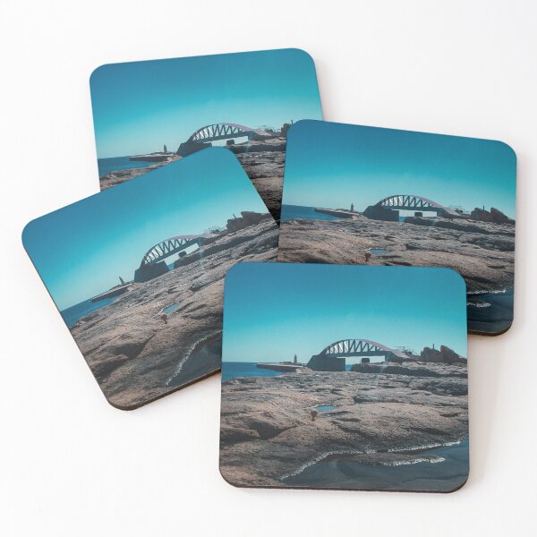 Item preview, Arched Bridge And Lighthouse Over Rocky Coastline At Calm Blue Sea During Clear Day designed and sold by Nmallia.
