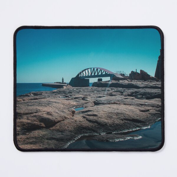 Item preview, Arched Bridge And Lighthouse Over Rocky Coastline At Calm Blue Sea During Clear Day designed and sold by Nmallia.