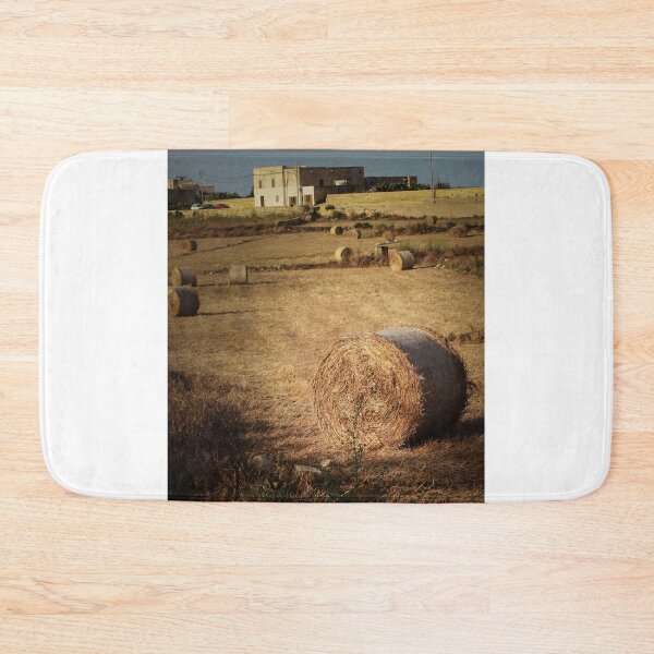 Item preview, Golden Hay Bales in Harvested Field Near Rural Farmhouses at Sunset Countryside Landscape designed and sold by Nmallia.