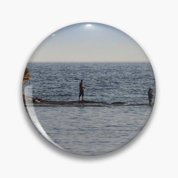 Item preview, Two Fishermen Fishing From Rocky Shoreline Near Cliffs At Calm Ocean Horizon During Evening designed and sold by Nmallia.