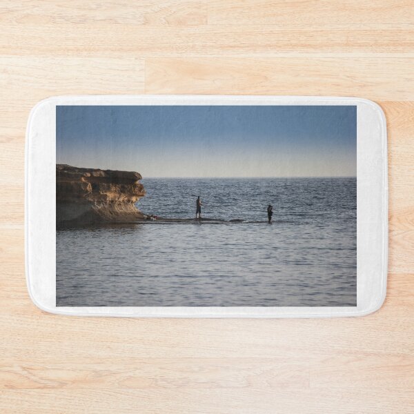 Item preview, Two Fishermen Fishing From Rocky Shoreline Near Cliffs At Calm Ocean Horizon During Evening designed and sold by Nmallia.