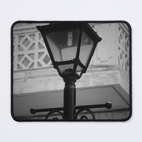 Item preview, Vintage Street Lamp In Black And White With Ornate Ironwork Against Old Building Facade designed and sold by Nmallia.