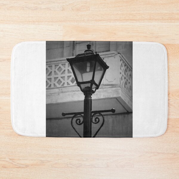 Item preview, Vintage Street Lamp In Black And White With Ornate Ironwork Against Old Building Facade designed and sold by Nmallia.