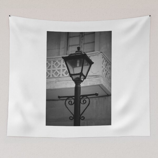 Item preview, Vintage Street Lamp In Black And White With Ornate Ironwork Against Old Building Facade designed and sold by Nmallia.