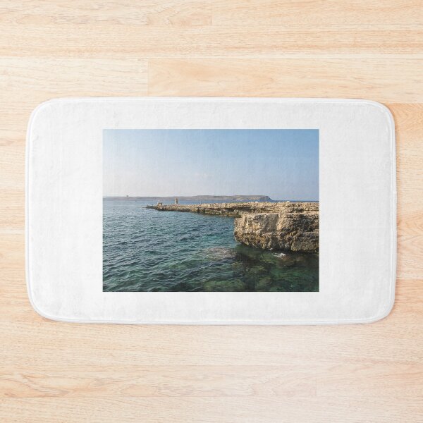 Item preview, Rocky Coastal Cliffs Over Clear Turquoise Sea With Submerged Rocks and Sunny Sky designed and sold by Nmallia.