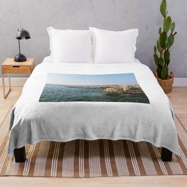 Item preview, Rocky Coastal Cliffs Over Clear Turquoise Sea With Submerged Rocks and Sunny Sky designed and sold by Nmallia.
