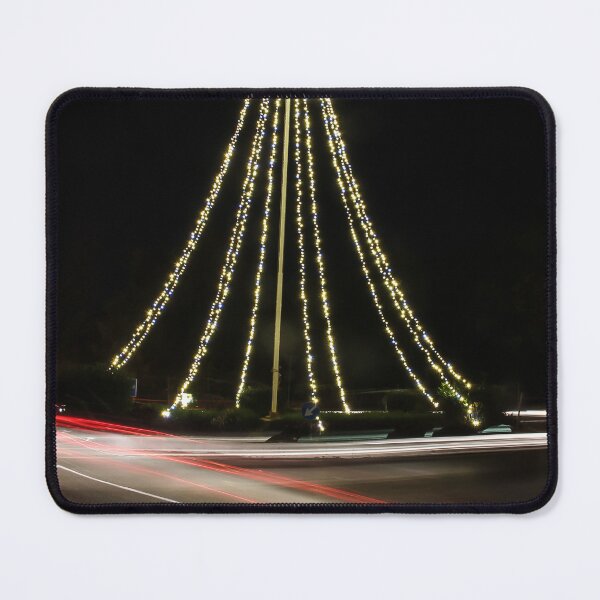 Item preview, Christmas Lights Tree on Roundabout With Long Exposure Traffic Light Trails at Night designed and sold by Nmallia.
