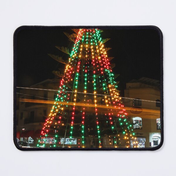 Item preview, Festive Christmas Tree With Colorful Lights and Star Topper Illuminating Nighttime Street designed and sold by Nmallia.