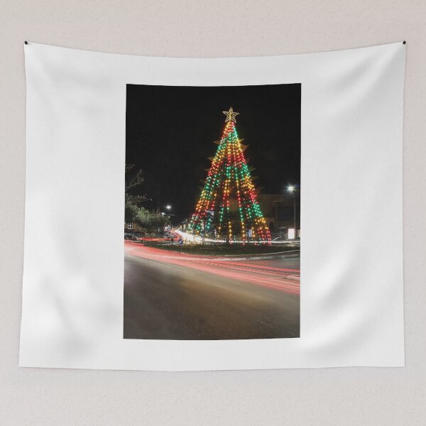 Item preview, Festive Christmas Tree With Colorful Lights and Star Topper Illuminating Nighttime Street designed and sold by Nmallia.