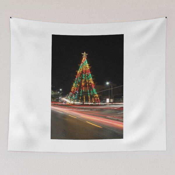 Item preview, Festive Christmas Tree With Colorful Lights and Star Topper Illuminating Nighttime Street designed and sold by Nmallia.