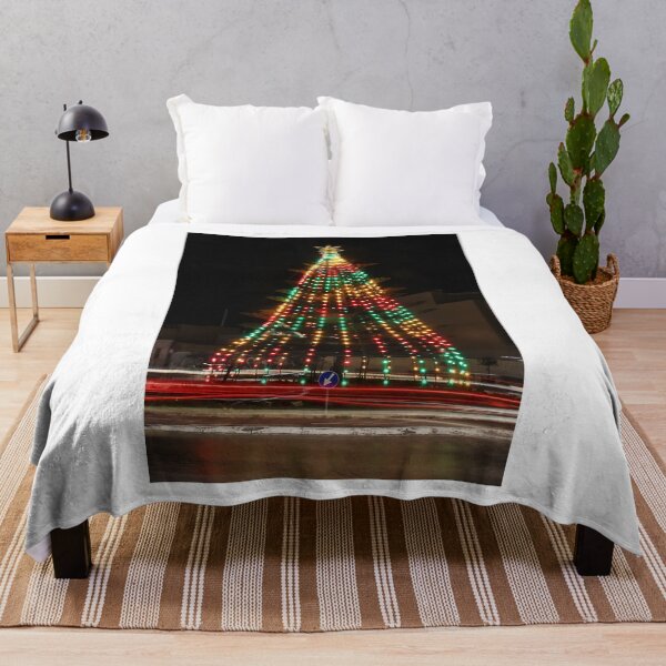Item preview, Festive Christmas Tree With Colorful Lights and Star Topper Illuminating Nighttime Street designed and sold by Nmallia.