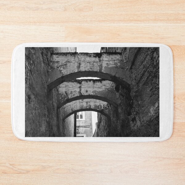 Item preview, Black And White Urban Alley With Weathered Stone Arches And Historic Textured Walls designed and sold by Nmallia.