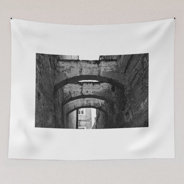 Item preview, Black And White Urban Alley With Weathered Stone Arches And Historic Textured Walls designed and sold by Nmallia.