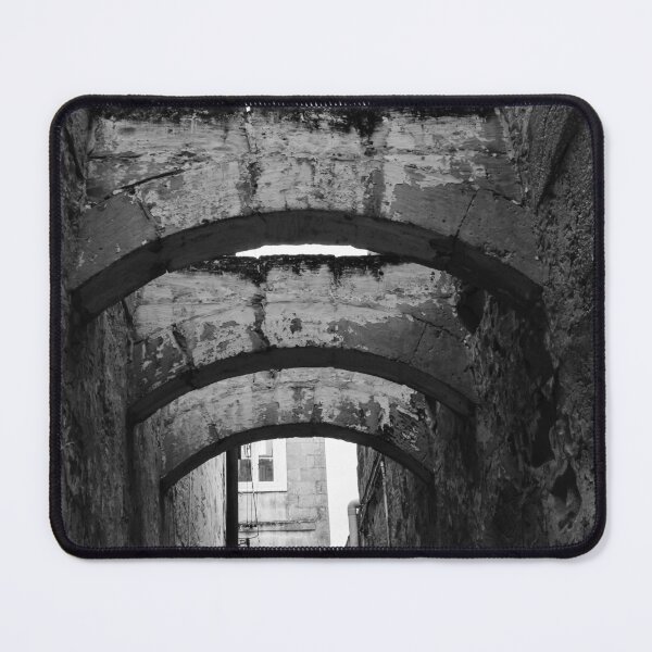 Item preview, Black And White Urban Alley With Weathered Stone Arches And Historic Textured Walls designed and sold by Nmallia.