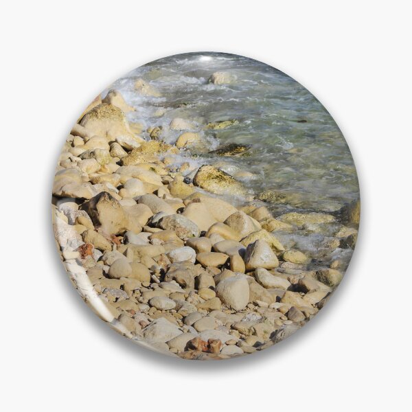 Item preview, Rocky Pebble Beach Shore With Clear Blue Sea Waves Lapping Over Stones On Sunny Coastline designed and sold by Nmallia.