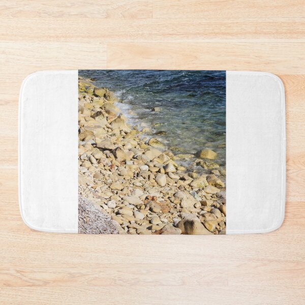 Item preview, Rocky Pebble Beach Shore With Clear Blue Sea Waves Lapping Over Stones On Sunny Coastline designed and sold by Nmallia.