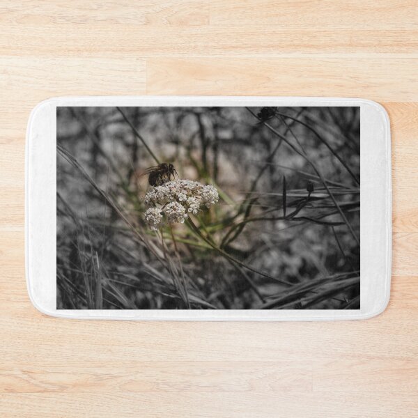 Item preview, Honey Bee Pollinating White Wildflower Among Grasses With Selective Color Shallow Depth Of Field designed and sold by Nmallia.