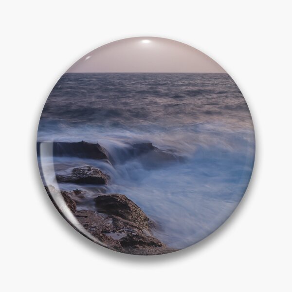 Item preview, Rocky Coastline With Waves Crashing Against Cliffs Near A Seaside Village At Dusk designed and sold by Nmallia.