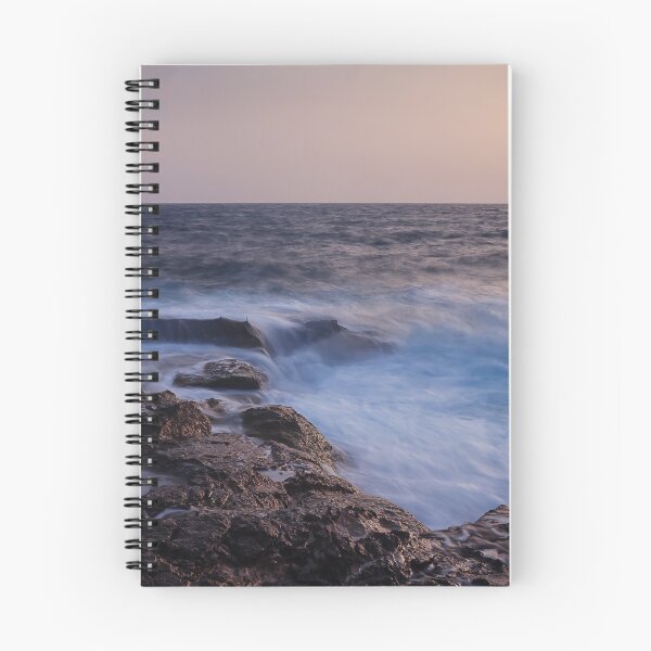 Item preview, Rocky Coastline With Waves Crashing Against Cliffs Near A Seaside Village At Dusk designed and sold by Nmallia.